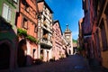 Scenic view of colorful half-timbered residences decorated with old shop signs in Riquewihr