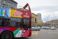 Scenic view of colorful red bus for city tour in Naples, Italy. People like sightseeing with comfort on a sunny summer day