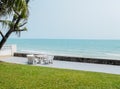 Scenic View Combining Four Part which are Grass Ground, White Stone Table in Decking, Blue Sea and Clear Sky as Copyspace