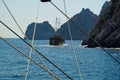 Scenic view through the cordage of a touristic sail boat in the turquoise waters of Mediterranean sea with a boat Royalty Free Stock Photo