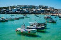 Scenic view of a cornish harbor with fishing boats at high tide in the summer in Cornwall, England