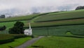 a small road and church sitting on top of the hill Royalty Free Stock Photo