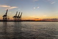 Scenic View of cranes at Hamburg Harbour durng sunset hour Royalty Free Stock Photo