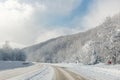 Scenic view of curve turn on beautiful mountain forest cpuntry woods highway road at cold snowy sunny weather winter day Royalty Free Stock Photo