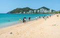 Scenic view of Dadonghai beach with people blue sky and peninsula view in Sanya Hainan island China