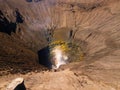 Scenic view of a dangerous deep volcanic hole cave in the ground Royalty Free Stock Photo