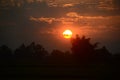 Scenic view dramatic beautiful sunset sky. Natural Sunset Sunrise on meadow silhouette shadow dark land. Vibrant dramatic sky on