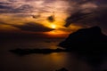 Scenic view of a dramatic sunset over the high mountains and the sea Royalty Free Stock Photo