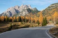 Scenic view of an empty mountain pass road and gorgeous forest changing colors. Royalty Free Stock Photo