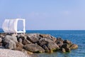 Scenic view empty white beach wooden canopies cabanas with white curtain blowing by wind against sea or ocean san Royalty Free Stock Photo