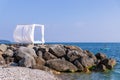 Scenic view empty white beach wooden canopies cabanas with white curtain blowing by wind against sea or ocean san Royalty Free Stock Photo