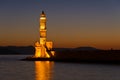 Scenic view of the entrance to Chania harbor with lighthouse at sunset, Crete Royalty Free Stock Photo