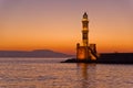 Scenic view of the entrance to Chania harbor with lighthouse at sunset, Crete Royalty Free Stock Photo