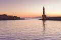 Scenic view of the entrance to Chania harbor with lighthouse at sunset, Crete Royalty Free Stock Photo
