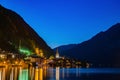 Scenic view of famous Hallstatt lakeside town reflecting in Hallstattersee lake in the Austrian Alps night time in summer, Royalty Free Stock Photo