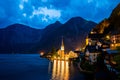 Scenic view of famous Hallstatt lakeside town reflecting in Hallstattersee lake in the Austrian Alps night time in summer, Royalty Free Stock Photo