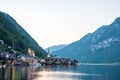 Scenic view of famous Hallstatt lakeside town reflecting in Hallstattersee lake in the Austrian Alps on a sunny day in summer, Royalty Free Stock Photo