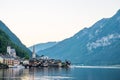 Scenic view of famous Hallstatt lakeside town reflecting in Hallstattersee lake in the Austrian Alps on a sunny day in summer, Royalty Free Stock Photo