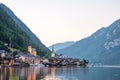 Scenic view of famous Hallstatt lakeside town reflecting in Hallstattersee lake in the Austrian Alps on a sunny day in summer, Royalty Free Stock Photo