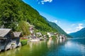 Scenic view of famous Hallstatt lakeside town reflecting in Hallstattersee lake in the Austrian Alps on a sunny day in summer, Royalty Free Stock Photo