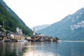 Scenic view of famous Hallstatt lakeside town reflecting in Hallstattersee lake in the Austrian Alps on a sunny day in summer, Royalty Free Stock Photo