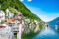 Scenic view of famous Hallstatt lakeside town reflecting in Hallstattersee lake in the Austrian Alps on a sunny day in summer, Royalty Free Stock Photo