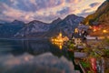 Scenic view of famous Hallstatt mountain village in the Alps under picturesque moving clouds after sunset, Austria