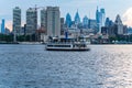 Scenic view of a ferry in the river Delaware with skyscrapers of downtown Philadelphia on the bank