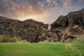 Scenic view of Gljufrafoss amidst mountains in valley against sky at sunset Royalty Free Stock Photo