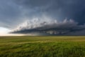 Expansive prairie landscape under a dramatically stormy sky filled with dark clouds Royalty Free Stock Photo