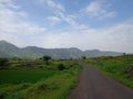 Scenic view of greenery landscape and hills and blue sky