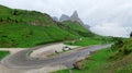 Scenic view of a hairpin turn of a mountain highway with rugged Cimon della Pala in background