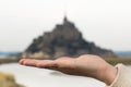 Hand holding Mont Saint-Michel in Normandy, France as a treasure Royalty Free Stock Photo