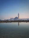 Scenic view of Hassan II mosque Reflected on water on a sunny day Royalty Free Stock Photo