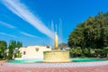 Scenic view of historic circular raised sculptural Electric Fountain under beautiful blue sky