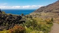 Scenic view on the horizon over the sea between steep vegetated mountains