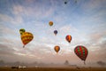 Scenic view of hot air balloons floating across a foggy landscape in Western Australia
