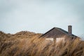 Scenic view of a house on the Bjerregard beach on a cloudy day in Hvide Sande, Denmark Royalty Free Stock Photo