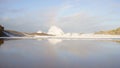 Scenic view of huge breaking waves at a distance approaching Castlepoint against blue sky