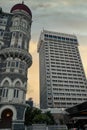 Scenic view of the iconic Taj Mahal Palace in Mumbai, India, against a dramatic, cloudy sunset sky