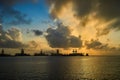 Scenic view of an industrial factory located on the shore during the sunset