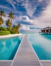 Tropical resort infinity pool with overwater bungalows Royalty Free Stock Photo