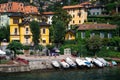 Scenic view of Italian villas and boats moored at the shore on Lake Como in Varenna, Italy. Royalty Free Stock Photo