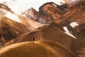 Scenic view of Kerlingarfjoll mountain range with couple tourists visiting on geothermal area on summer at Highlands of Iceland