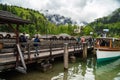 Scenic view on Konigssee Lake with wooden pier with moored touristic ship