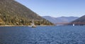 Scenic View of Kootenay River with Sailboat.