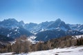 Scenic view of snow covered mountain range and forest against clear blue sky Royalty Free Stock Photo