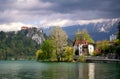 Scenic view of Lake Bled with castle, villas and mountains covered by clouds on background at springtime, Slovenia Royalty Free Stock Photo