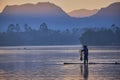 Scenic view of a lake in a quiet morning with silhouette of a fisherman