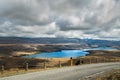 Road in the mountains, Lake Tekapo, and dramatic cloudy sky, North Island New Zealand Royalty Free Stock Photo